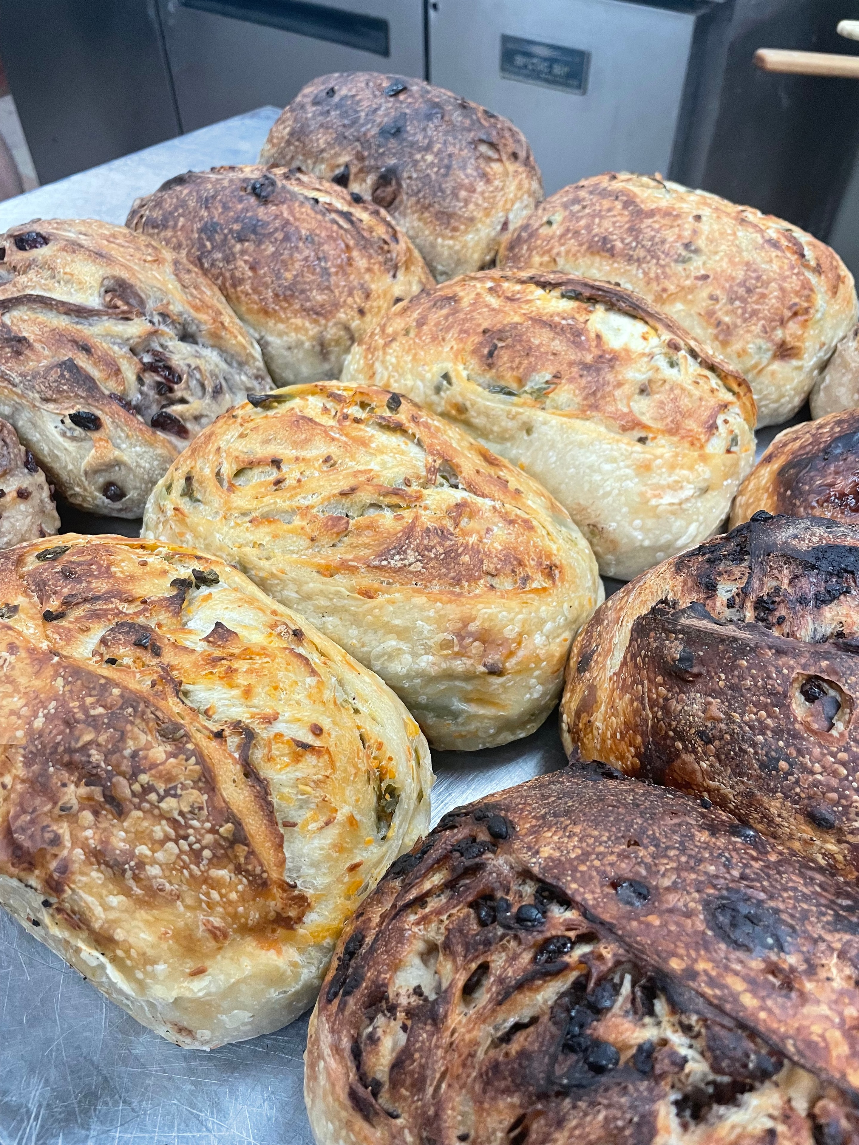 Freshly baked artisan rolls on a tray